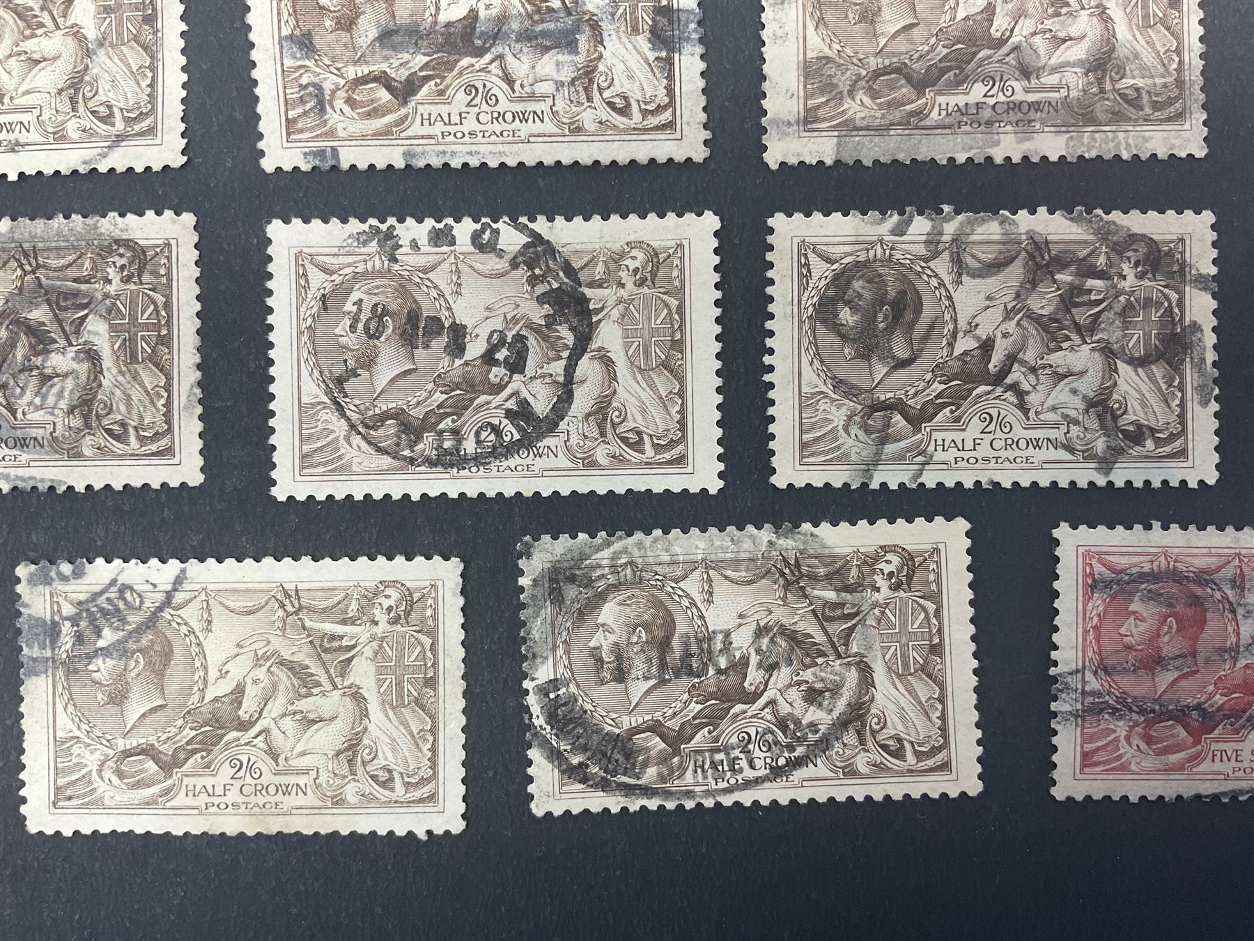 Great Britain King George V seahorse stamps, comprising fourteen half crown, seven five shillings and two ten shillings, all used, all previously mounted