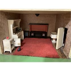 Large Tri-ang No.93 doll`s house in the 'Stockbroker's Range' c1935; two-storey double-fronted Tudor design, half timbered gables, two-storey bay windows, cream and mock shrubbery to front, opening metal framed windows with green shutters, red simulated tiled roof with chimney, integral garage with opening doors, front elevation has four hinged doors opening to reveal two bedrooms with fire places, living room, bathroom and kitchen with built in dresser and sink, entrance hall and staircase, side entrance with porch and seat and sun dial over on chimney stack; some wiring for electrical lighting; metal Tri-ang Toys disc verso; comprehensively furnished H66cm L117cm D43cm