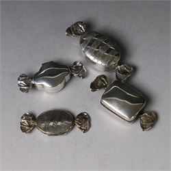 Four novelty silver pill boxes, in the form of wrapped sweets, all hallmarked, largest W6cm