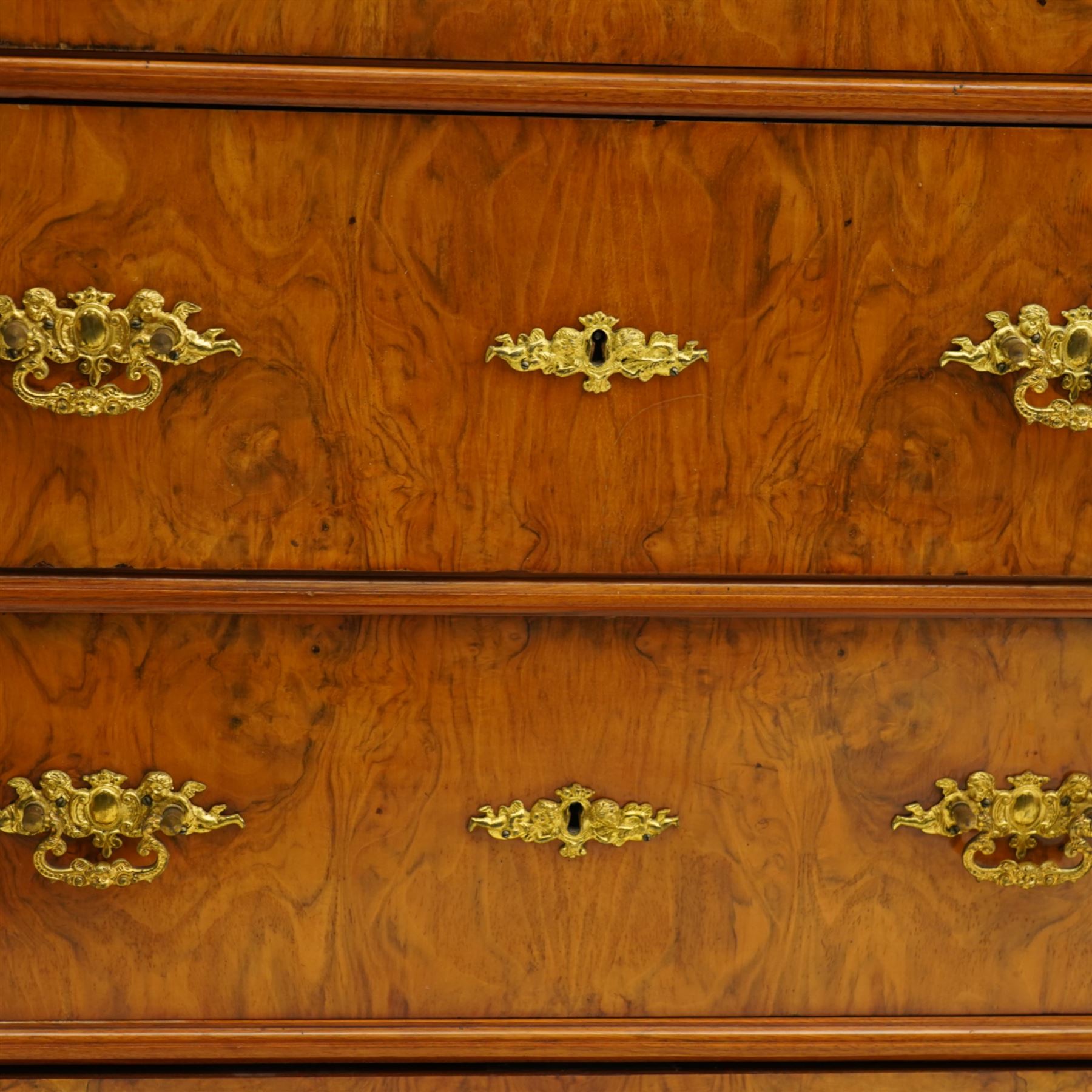 Tall late 19th century walnut chest, stepped and moulded top over six drawers, ornate cast gilt metal handles, enclosed by turned and fluted upright columns, on turned front feet 