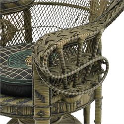Mid-20th century wicker and rattan Peacock chair in unusual tones of dark olive and black, high fan back with a pieced and woven frame terminating to scrolled arms, with loose seat cushion