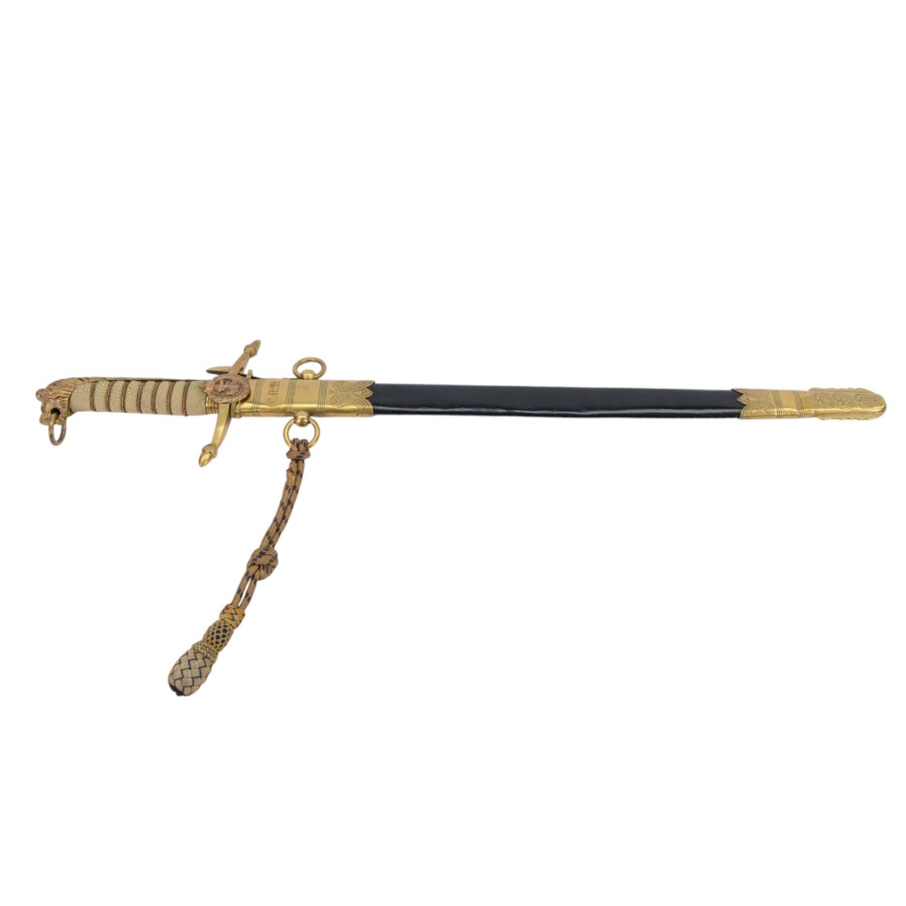 George V midshipman`s dirk, the 45cm straight single edged blade, length etched with crowned GRV cypher and anchor foliate scrolls, gilded brass hilt with lion`s head pommel and wirebound fishskin covered grip, in brass mounted leather sheath, the upper mount engraved  'C.R.B', with a cord and wire knife knot, overall L6cm` 