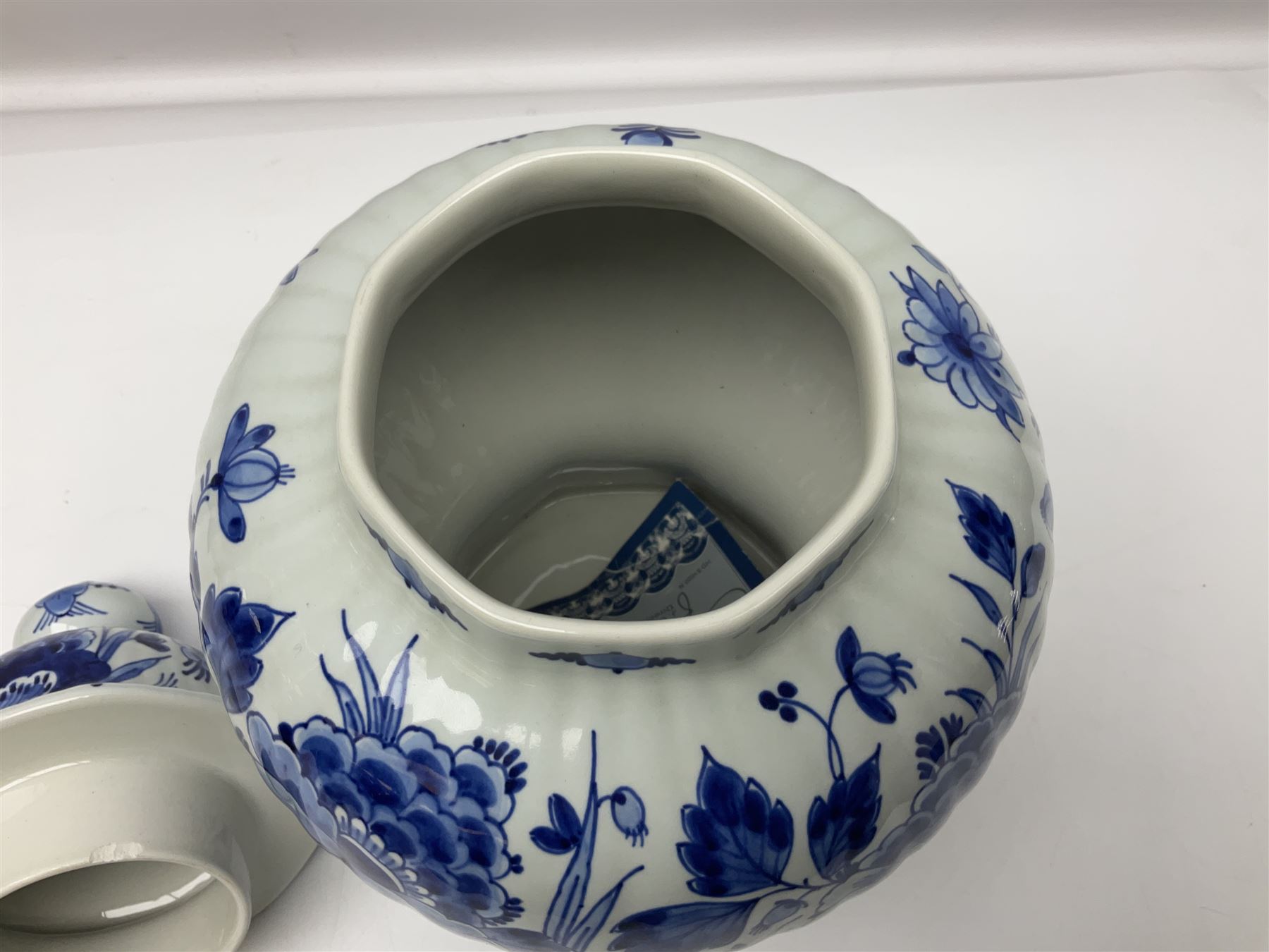 De Porceleyne Fles Delftware blue and white covered jar, of fluted baluster form, with floral and insect decoration, upon an octagonal foot, the octagonal cover with urn shaped finial, H32cm
