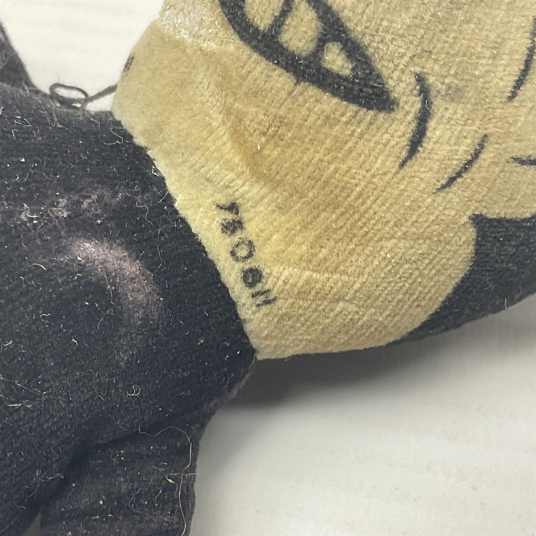 Deans Rag Book Mickey Mouse soft toy, circa 1930's, black velveteen head and body, with cream face and hands, red shorts and yellow felt shoes with leather soles, marked Reg. No. 750811 to neck H20cm; mid-20th century woodwool filled plush covered teddy bear with revolving head, applied eyes, vertically stitched nose and mouth and jointed limbs H52cm; soft toy figure of Rupert Bear; and Japanese clockwork tin-plate and plush covered mechanical toy of a gnome riding a donkey (4)