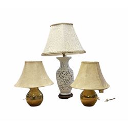  Blanc de Chine ceramic table lamp having a pierced body with lattice work decoration upon a wooden base, together with a pair of metal bulbous form table lamps, tallest example 48cm