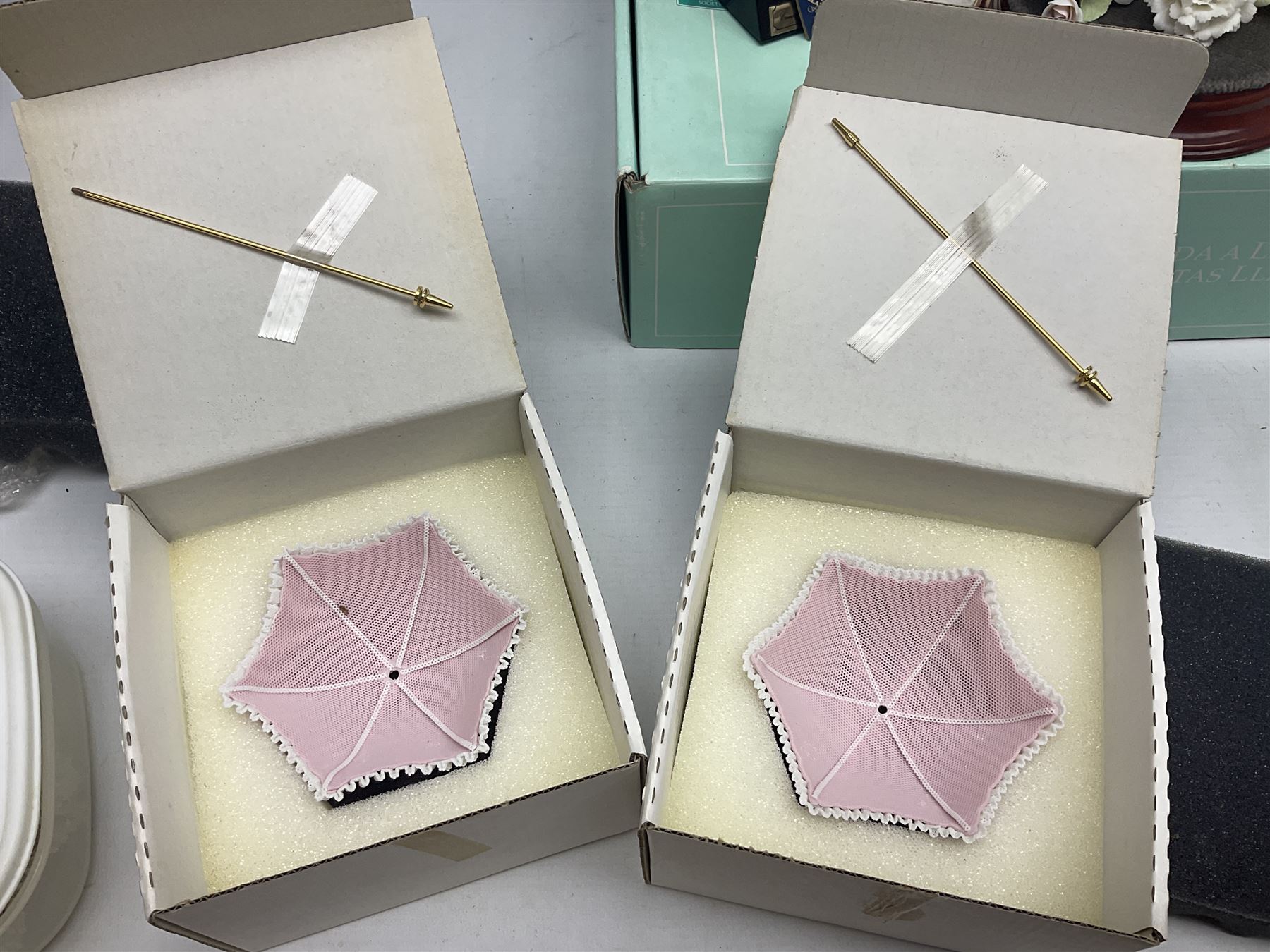 Seven Lladro flowers, comprising Japanese Camelia on base no 5181, Yellow Begonia on base no 5186, Miniature Begonia on base no 5188, Chrysanthemum on base no 5189, California Poppy no 5190.B, Miniature Begonia 5188.B and White Carnation no 5184.B, together with Lladro Spanish Joining pack with 17616 Winter Bell, Additional Lladro parasols and flowers etc 