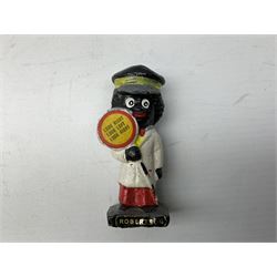 Robinson Jam plaster Golly band, including drummer and singer, H7.5cm

Originally handmade by mothers in Africa for their children from old fabric and cloth, the golly doll was adopted as the mascot and trademark for the Robertson's confectionery brand around 1910 after the company's founder John Robertson visited the US and noticed children playing with them. Robertson's Gollies have been collected by people across the UK and around the world for generations but garnered a contentious image in the 1980s because of links to racism. The trademark was removed from Robertson's branding in 2001.