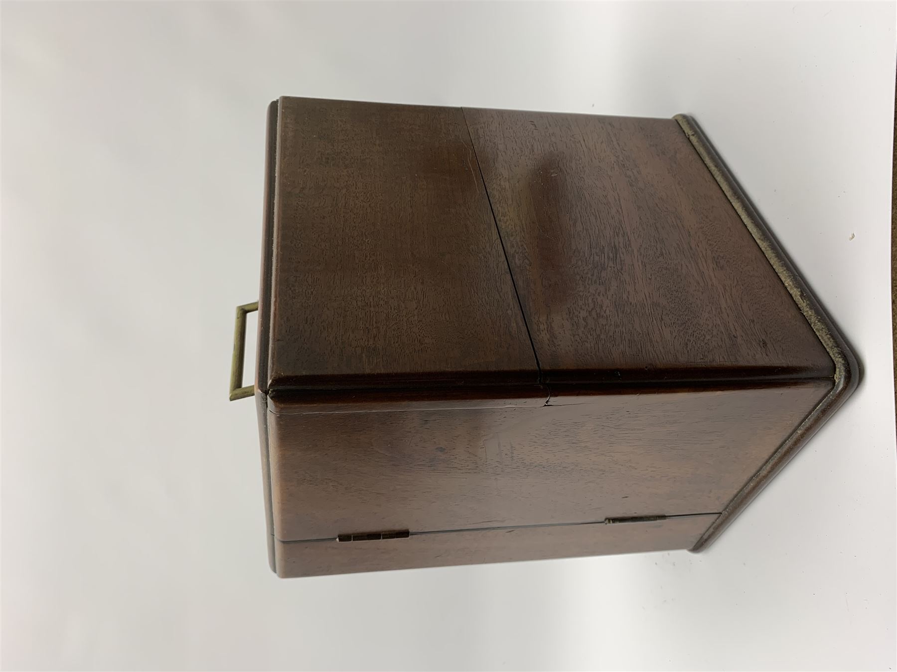 19th century mahogany travelling apothecary cabinet, with recessed brass carry handle to top, and two deep-section hinged doors to the front opening to reveal a fitted interior with clear glass bottles and two drawers, H27cm