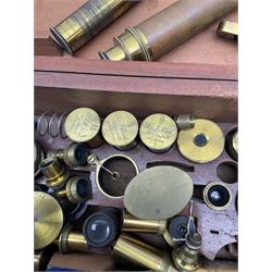 19th century students small brass cased field microscope H15cm; and approximately fifty predominantly brass microscope spare parts including pitchfork base, tubes, various lenses, lens canisters by R. & J. Beck and others, mirrors etc, in unrelated Victorian mahogany fitted box