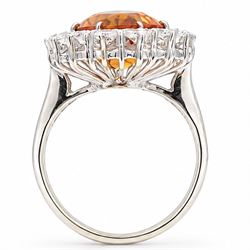 18ct white gold citrine and diamond cluster ring, single oval cut citrine of approx 4.30 carat, surrounded by sixteen round cut diamonds, total diamond weight approx 0.95 carat