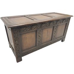18th century oak blanket box or coffer, triple panelled hinged lid and front, the front carved with lunettes and flowerhead guilloche decoration 