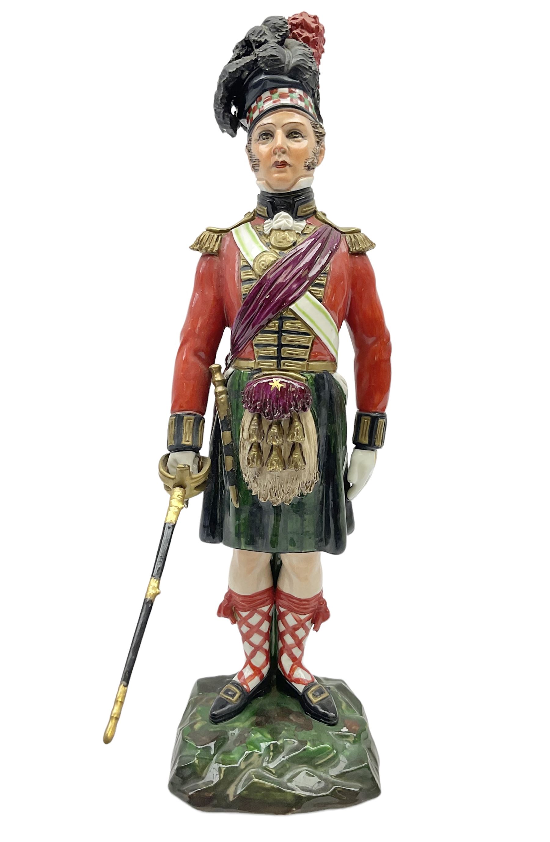 Sitzendorf figure, The Black Watch officer, c1815 standing to attention in full dress with sword, blue factory marks beneath, H28cm