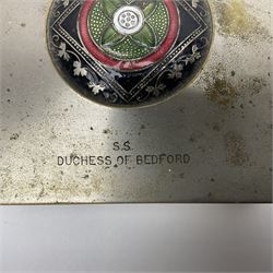 Early 20th century silver plated cigarette box, of rectangular form, the hinged cover with circular, black red and green floral and foliate enamel roundel to centre and engraved S.S. Duchess of Bedford, with softwood interior, H5cm, W10.5cm
