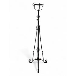 Late 19th century wrought iron and brass pulpit lamp, featuring an adjustable stem with a spiral twist detail, brass foliate mounts, and a tripod base with scrolled feet and decorative floral accents