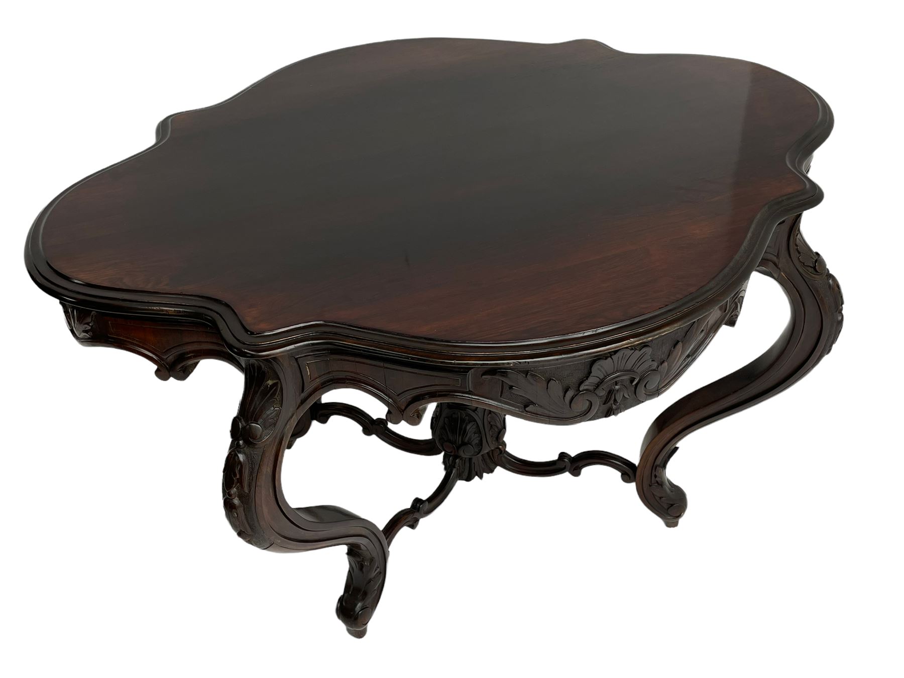 19th century Irish rosewood centre table, the shaped and moulded top over shaped apron carved with scrolled foliage, on serpentine supports carved with bell flowers, the supports united by anthemion carved finial and s-scroll x-framed stretchers