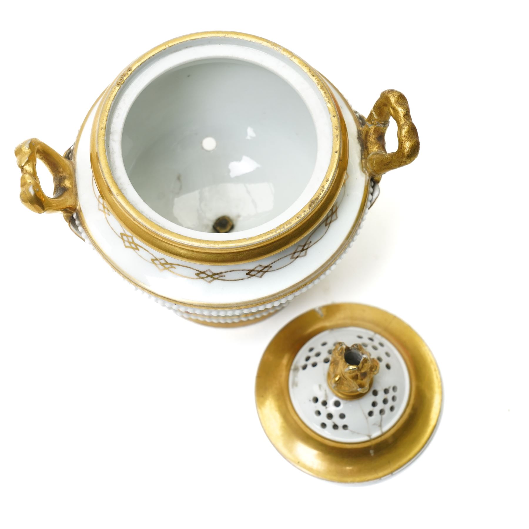 Pair of early 19th century potpourri, possibly Swansea, with twin gilt mascaron handles, the body painted with flowers on a gilt ground, spurious mark in red to base, H13cm  