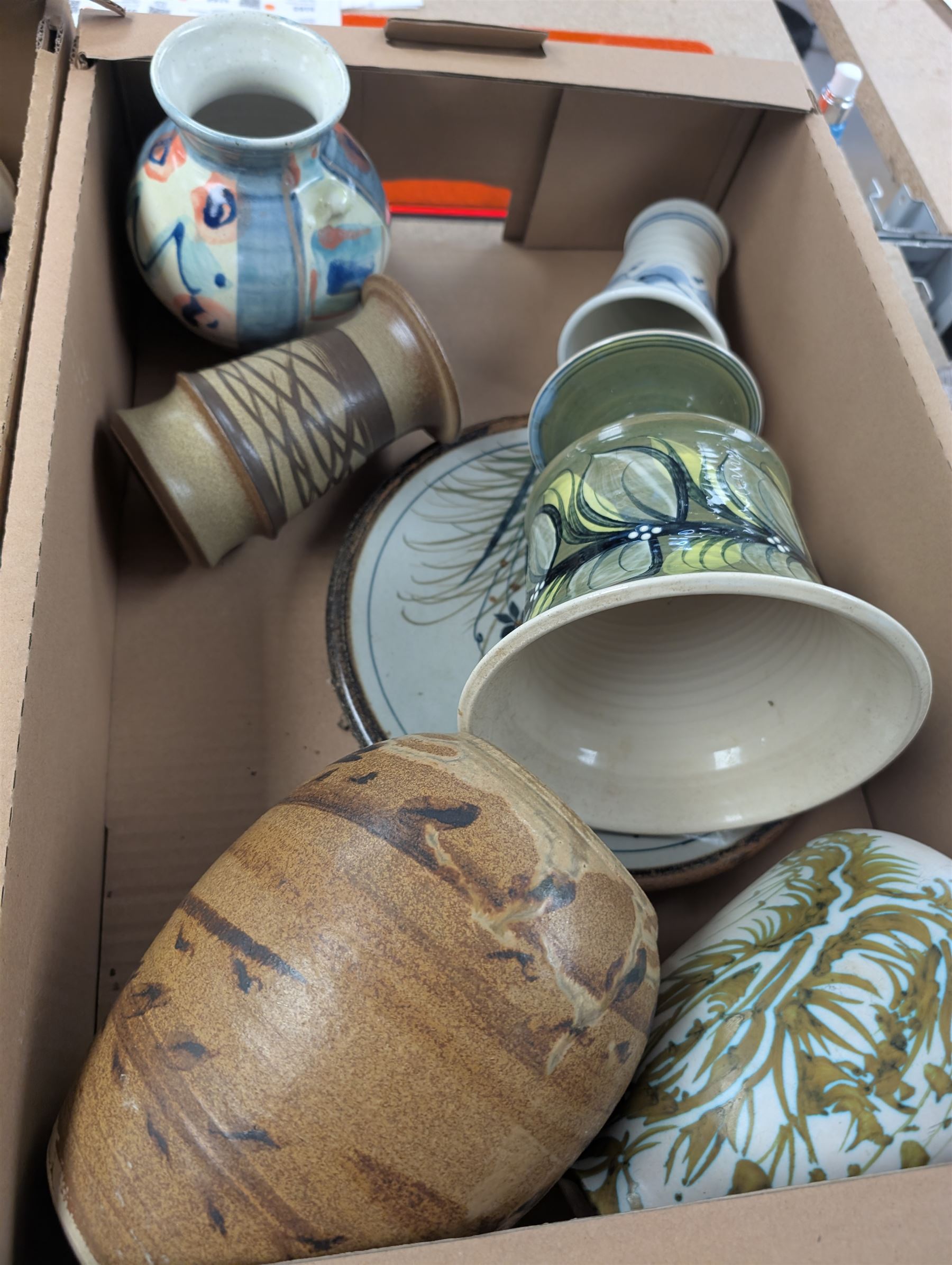 Collection of studio pottery, including bowls, vases, goblets and bottles, in four boxes 