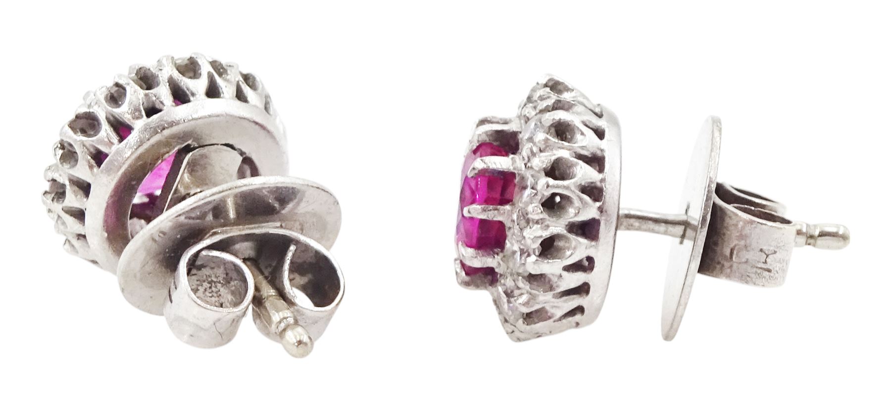 Pair of platinum and white gold round cut ruby and round cut diamond cluster stud earrings, total ruby weight approx 1.35 carat, total diamond weight approx 0.20 carat