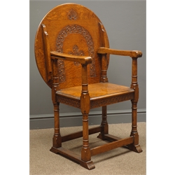  Early 20th century medium oak monks chair, guilloche carved back and rails, turned supports on sledge feet, W70cm  