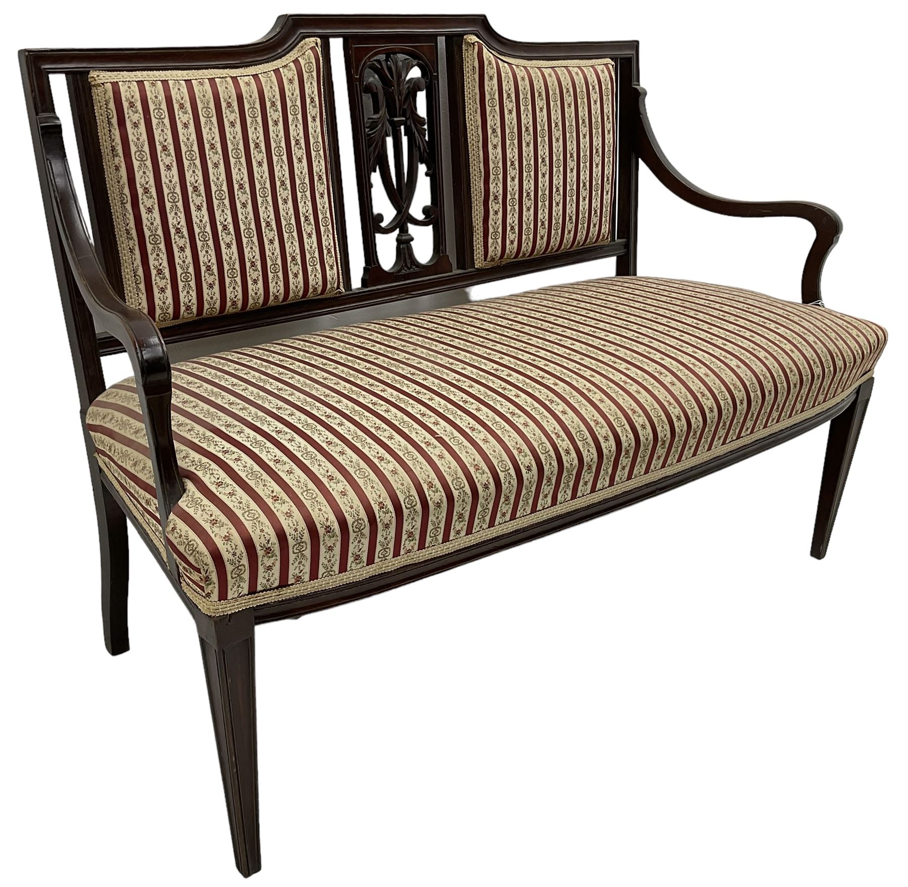 Edwardian mahogany framed three-piece salon suite - two-seat sofa, stepped cresting rail over acanthus and scroll carved pierced splat, upholstered in striped fabric (W124cm, H87cm, D62cm); and a pair of matching armchairs (W60cm) 