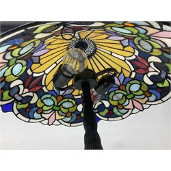Tiffany style table lamp upon cast spreading foot with leaded glass shade, H55cm