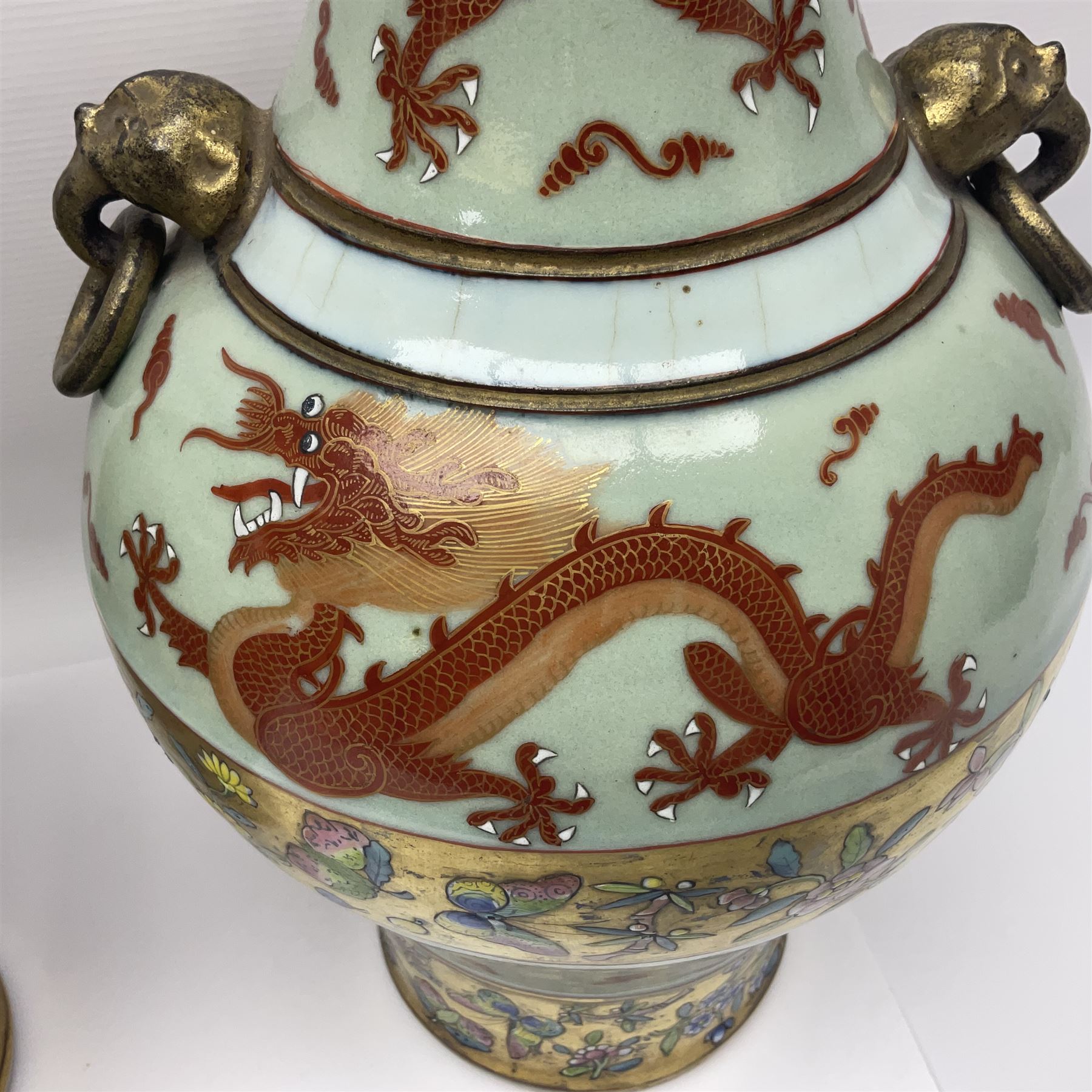 Pair of early 20th century Chinese vases decorated with dragons chasing a flaming pearl, with a gilt border of butterflies and floral sprigs, with Elephant head handles, H44cm 