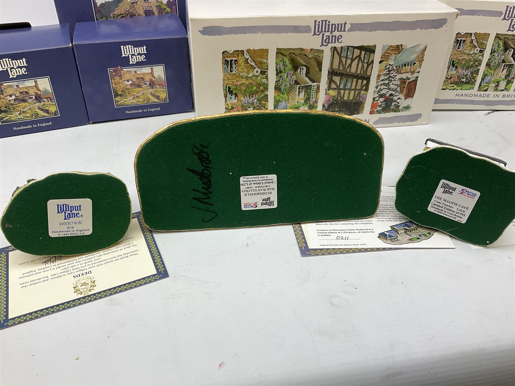 Eight Lilliput Lane models, including Gertrude's garden, Cruck End, Honeysuckle cottage, The Pottery, Huddersfield Railway Station, The Magpie Cafe, Amberly Rose, Summer Days and Shades of Summer, all boxed with deeds