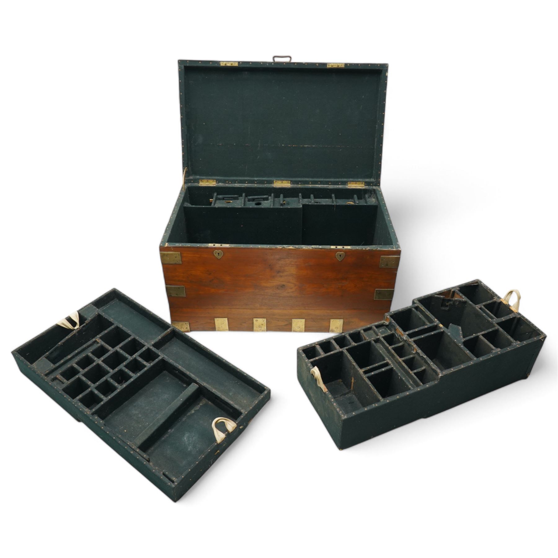 Early 19th century teak and brass bound silver campaign chest, fitted with brass L-shaped brackets and heavy weight carrying handles, the hinged lid enclosing two removeable trays with divisions and lined in blue baize, fitted with two 'R. Cooper & Son' brass locks