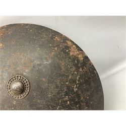 Indian black lacquered hide shield/dhal, of circular convex form fitted at its centre with four pierced iron bosses, each of hemispherical form with wide brims, the bosses corresponding on the inside with four iron rings for enarmes D53.5cm