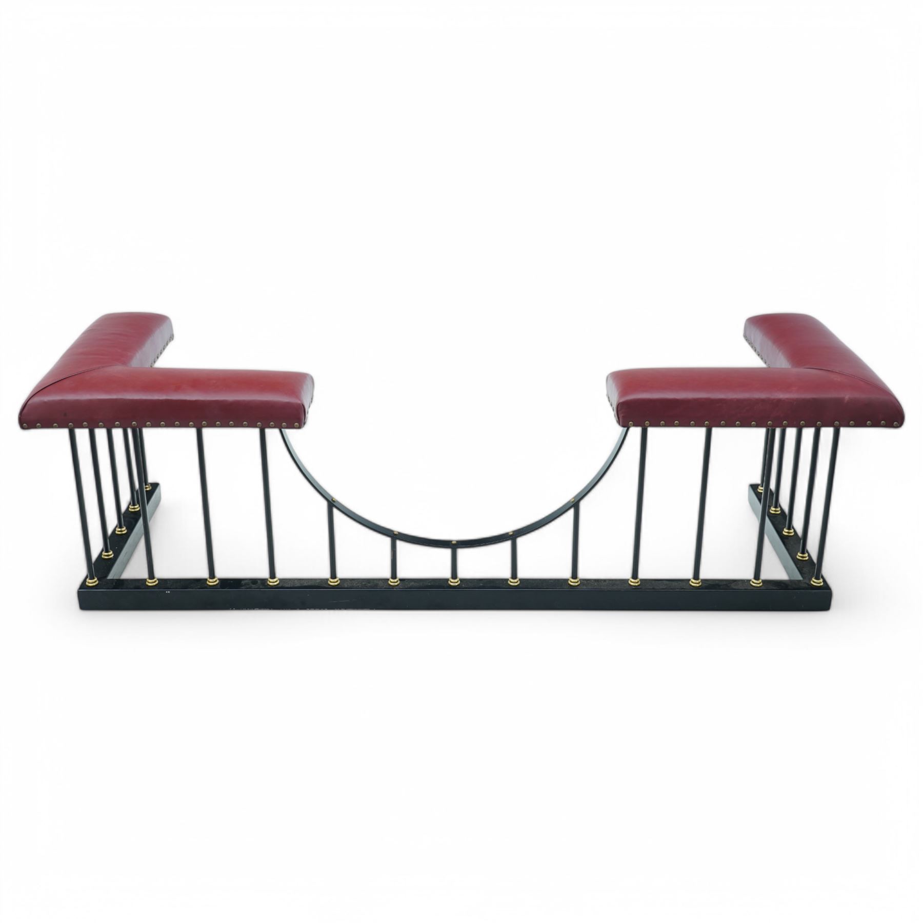 Wrought metal and brass fire fender, L-shaped corner seats upholstered in burgundy fabric with stud bands, dished centre on balustrade and plain curb  