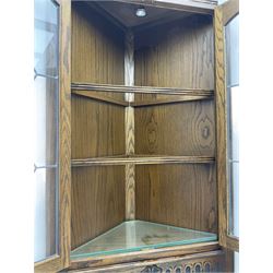 Pair of Old Charm oak corner display cabinets, fitted with lead glazed doors