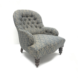  Victorian spoon back armchair, upholstered in a deep buttoned patterned fabric, turned supports, W69cm  