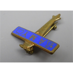  Amy Johnson Souvenir pin badge in the form of an blue enamelled aeroplane, the wing inscribed Amy with maps, RFC. approved No. 755555` by Miller, L2.5cm  