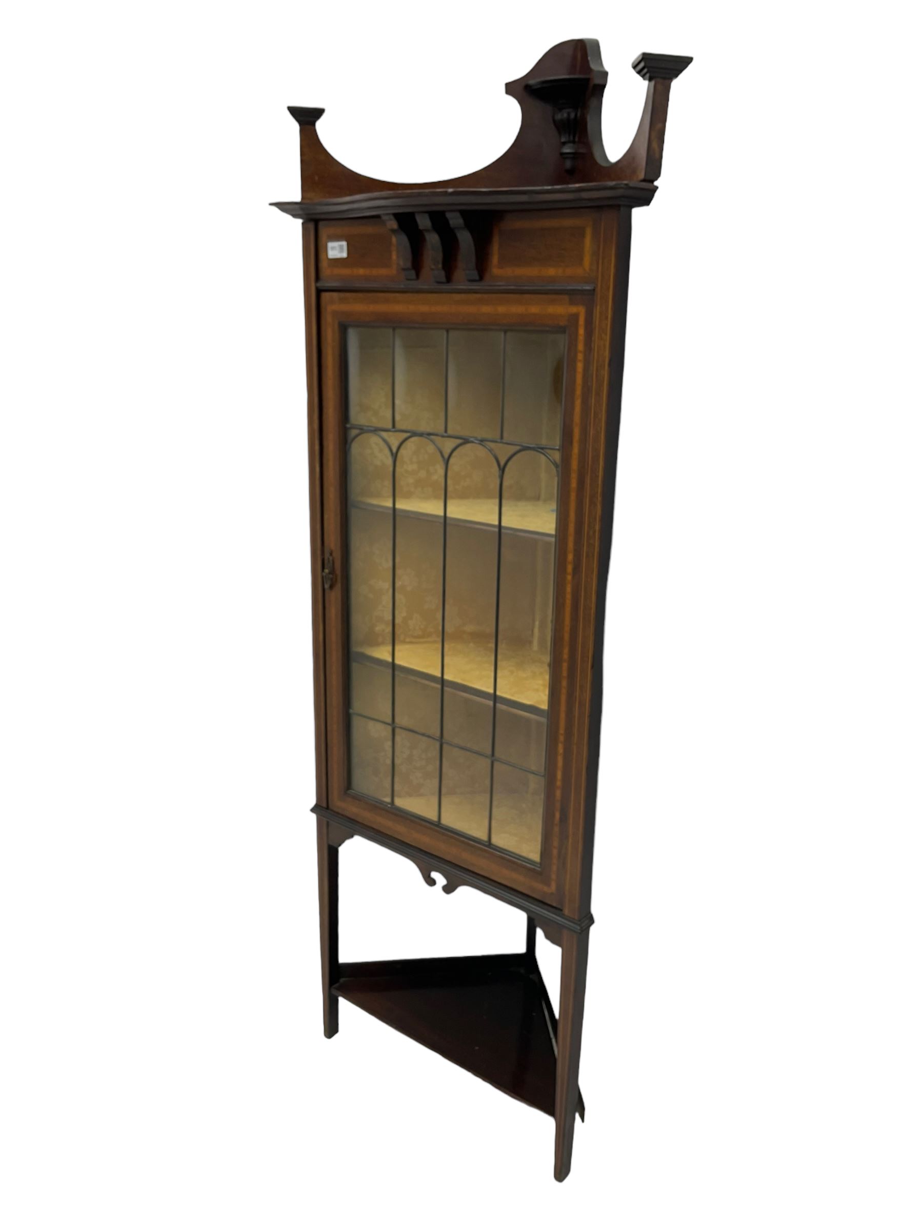 Edwardian inlaid mahogany corner cabinet, fitted with single astragal glazed door enclosing two shelves, flanked by satinwood banding, on square tapering supports united by undertier