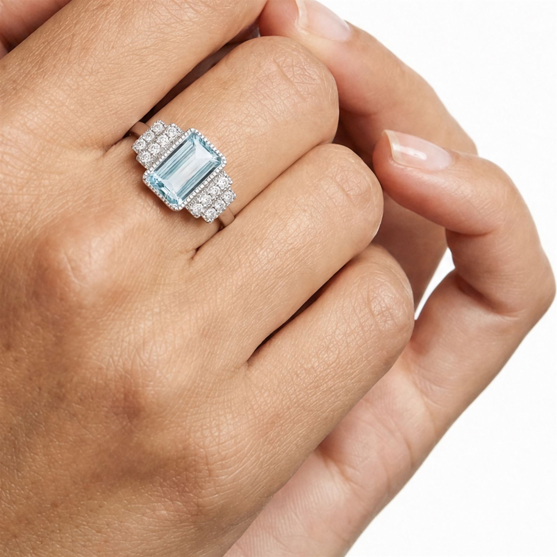 18ct white gold aquamarine and diamond stepped design ring, single milgrain set octagonal cut aquamarine of approx 7.00 carat, with seven round brilliant cut diamonds set either side, stamped 750, total diamond weight approx 0.40 carat