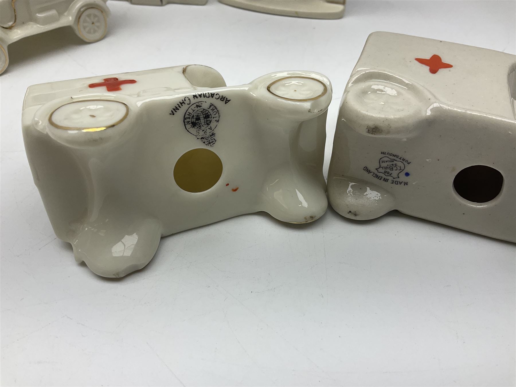 Ten WW1 crested china military models comprising seven field ambulances and three 'Home Fires Burning' fire-surrounds/range; various makers including Willow Art, Arcadian China, Grafton China, Savoy China, Carlton China etc; various crests including Devon, Aldershot, Portsmouth, West Ham, Coventry, Oxford, Hastings, Brighton etc (10)