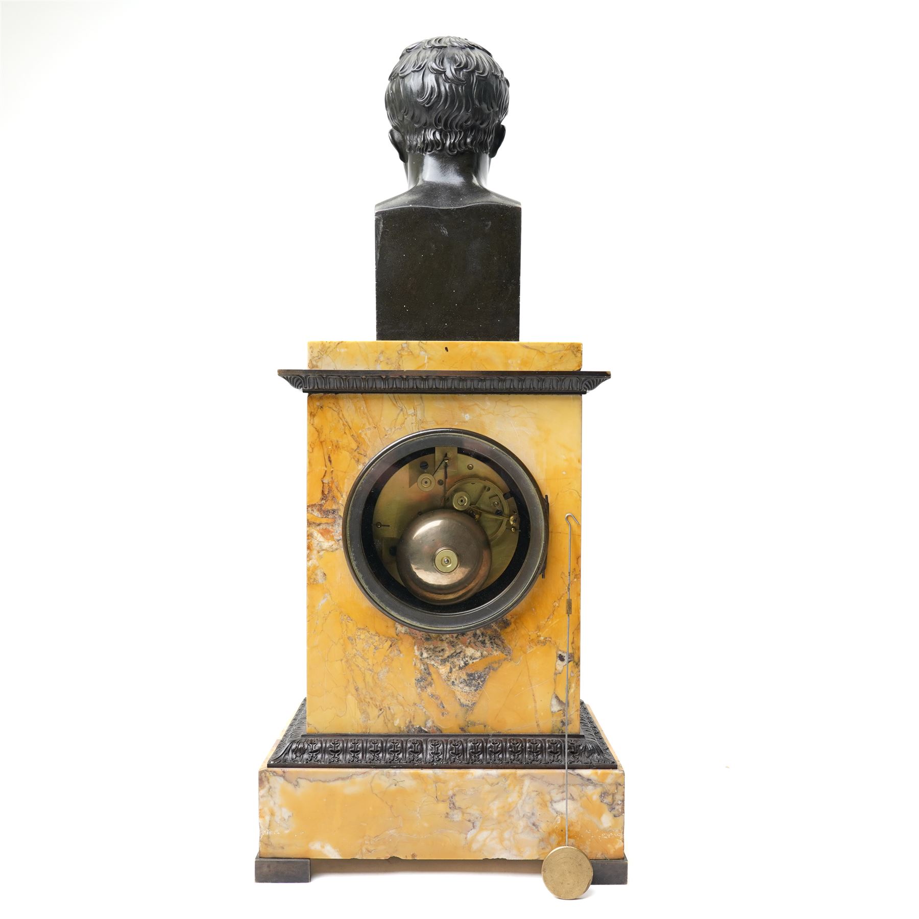 French-First quarter 19th century 8-day sienna marble and bronze-mounted mantel clock of rectangular architectural form, with patinated foliate guilloche pattern cast bronze mounts  in richly figured sienna marble, surmounted a by a classical patinated bronze bust of Napoleon Bonaparte, above a gilt engine turned dial with Roman numerals and blued steel hands, with a twin train Parisian countwheel striking movement, striking the hours and half-hours on a bell, silk suspension with thumb-screw adjustment. With pendulum.