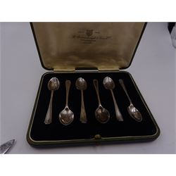 Set of 1930s silver handled fruit knives and forks, for six place settings, the handles decorated in relief with fruiting vines, hallmarked Walker & Hall, Sheffield 1934, together with a set of six 1920s silver egg spoons, with pin prick engraving to handle, hallmarked Thomas Bradbury & Sons Ltd, Sheffield 1929, in fitted case, three silver napkin rings, to include a pair, of octagonal form, with floral engraving, hallmarked John Rose, Birmingham 1951 and two silver souvenir spoons
