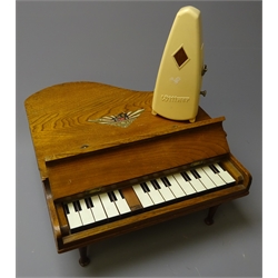  1950's miniature elm cased grand piano by S.K, L36cm and a  Wittner W.Germany Metronome in Art Deco style bakelite case H19cm (2)  
