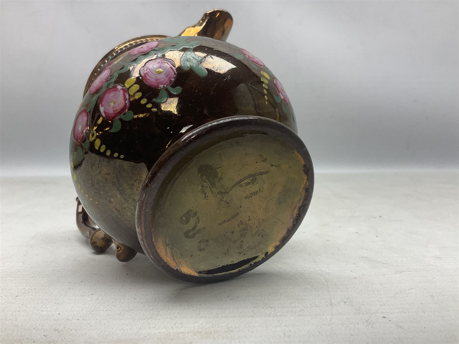 Early 20th century Sunderland lustre jug, decorated with transfer Masonic scene and poem 'The World is in Pain/Our Secrets to Gain/But Still Let Them Wonder and Gaze/The Never Can Divine/The World Nor The Sign/Of a Free and Accepted Mason', the reverse decorated with Sunderland River Wear cast iron bridge scene below text (a/f), together with a copper lustre jug, and pink lustre bowl, jug H20cm