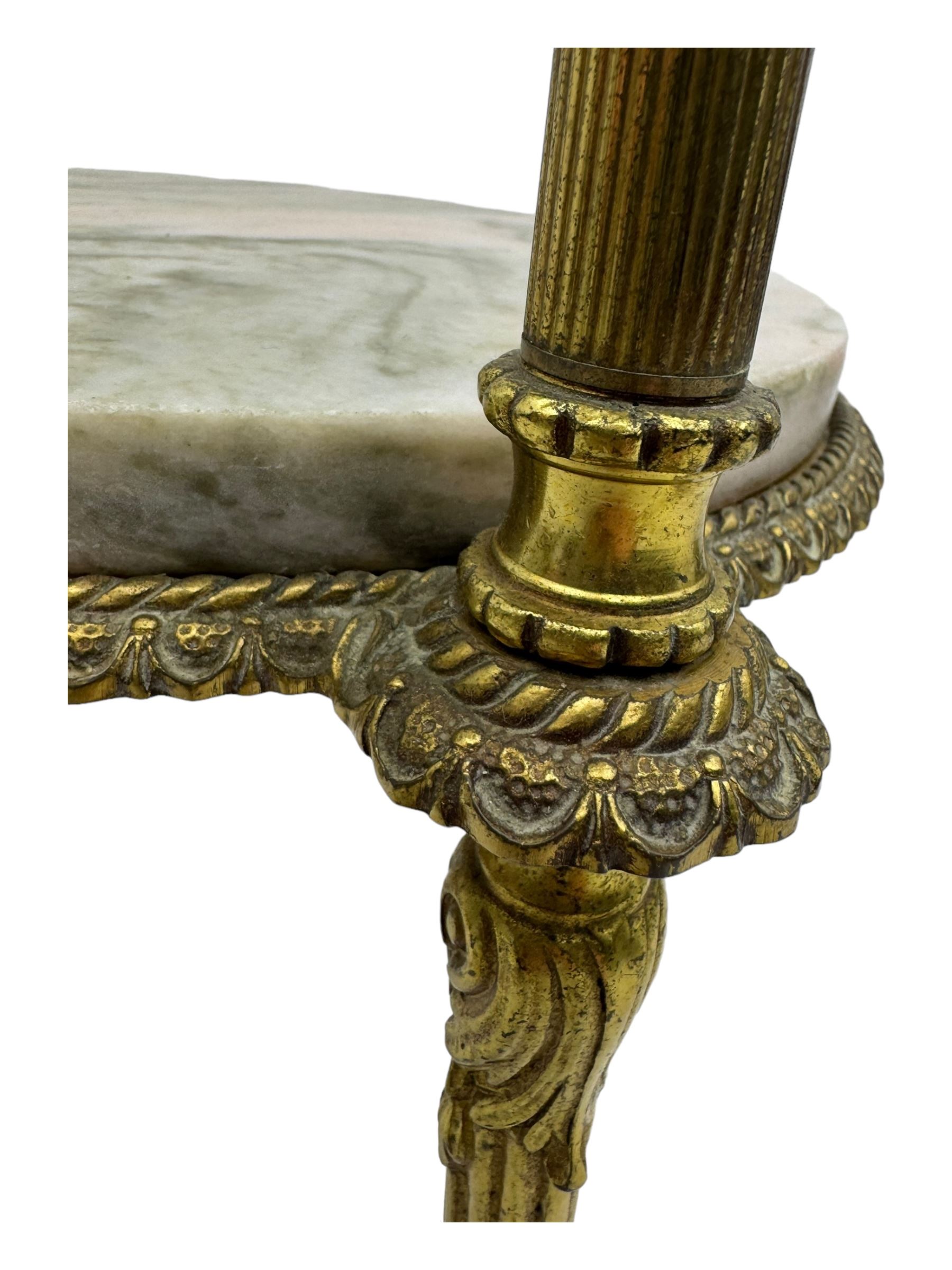 Late 20th century cast gilt metal and marble two-tier stand, pink and grey marble top and undertier, the base decorated with floral garlands, on reed moulded supports with splayed terminals 