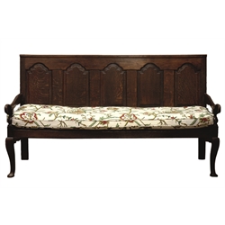  George III oak settle, the back with five raised and fielded panels and shaped arms, on cabriole legs with pad feet, the loose seat cushion embroidered with scrolling foliage, W183cm, H102cm, D69cm  