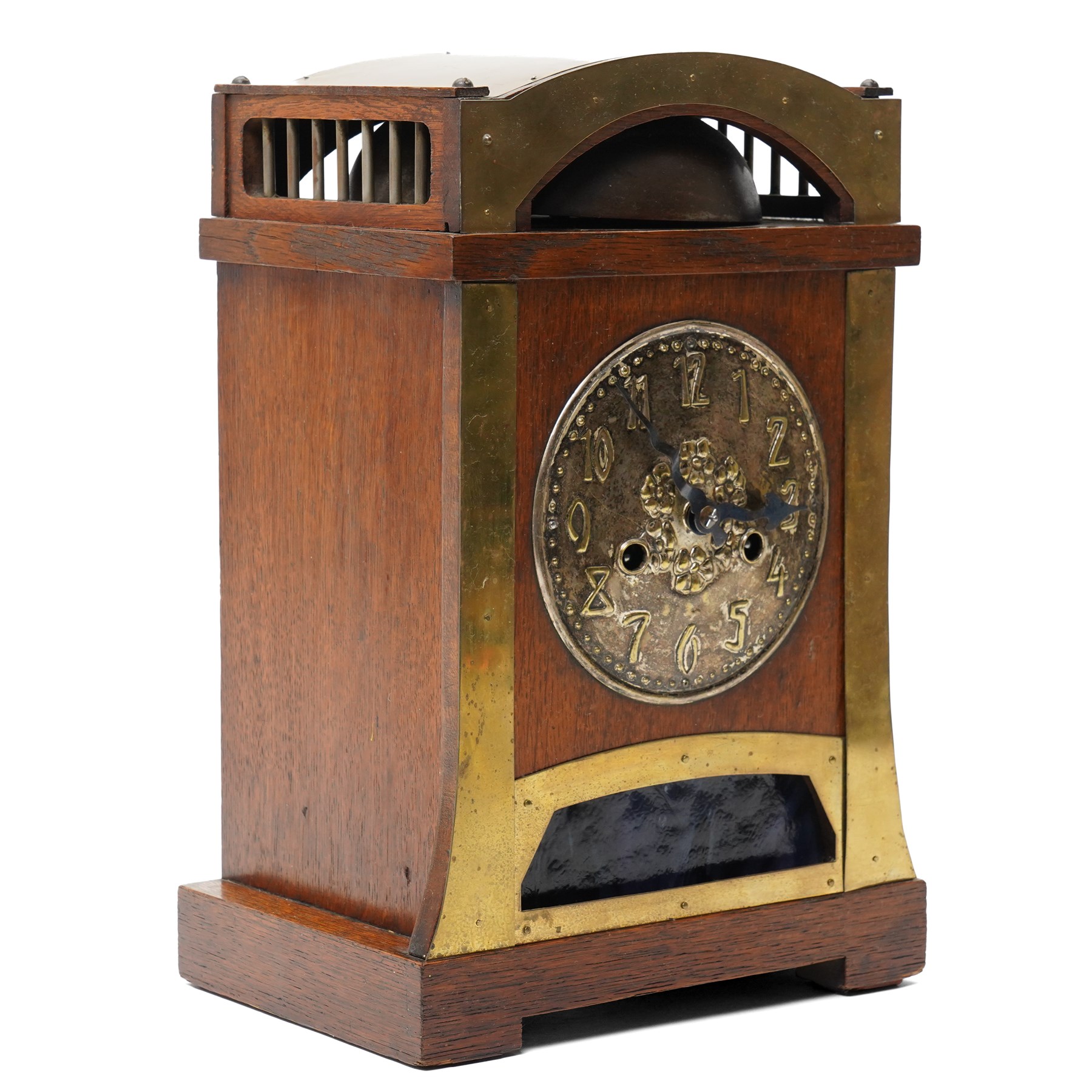 Arts and Crafts oak and brass mounted mantel clock, Hamburg-American Clock Company (HAC), for Liberty & Co, the eight day movement with bell strike, repousse dial with Arabic numerals H36.5cm

  