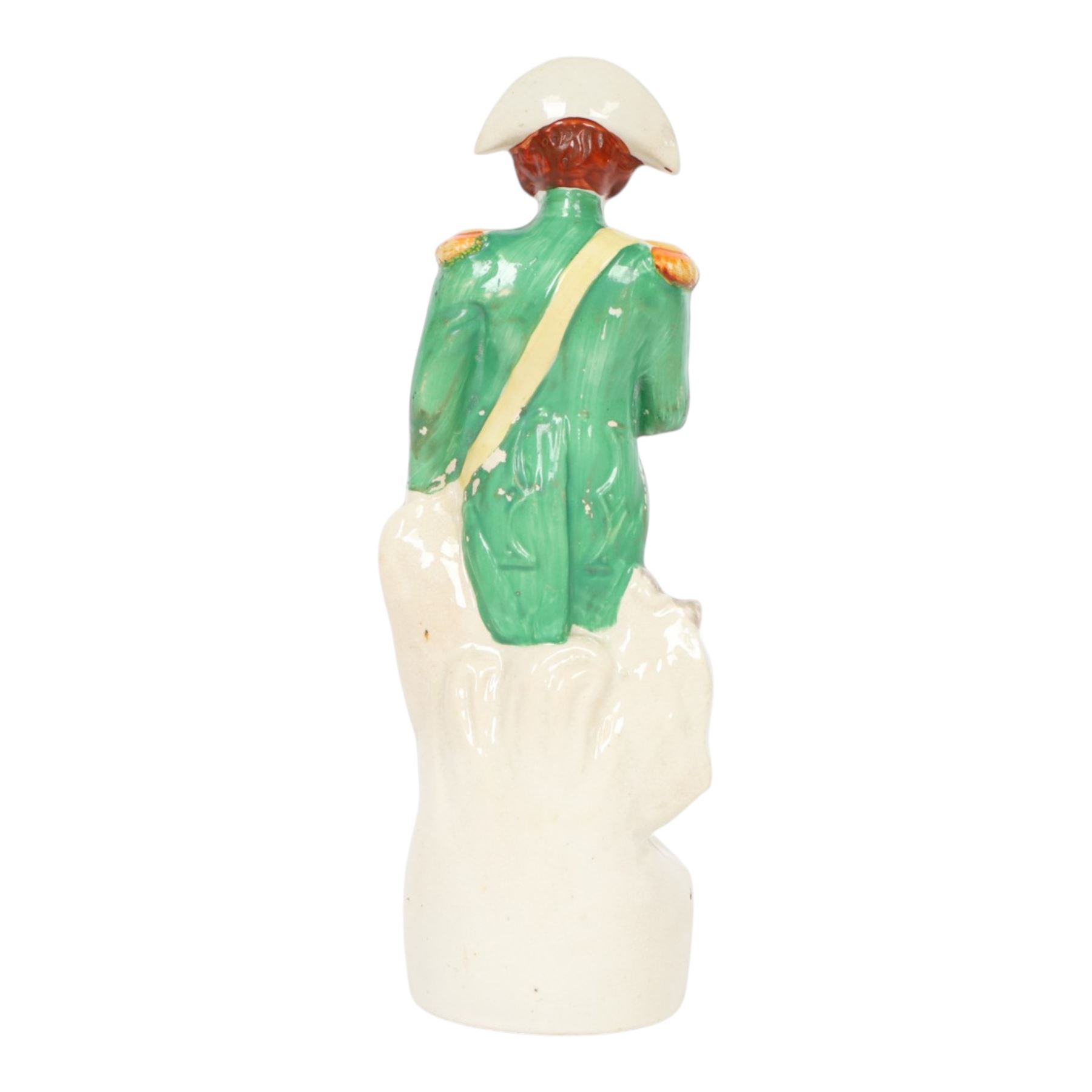 Rare mid 19th century Staffordshire pottery figure of Admiral Lord Nelson, modelled standing in uniform with green tunic, beside anchor, H27cm