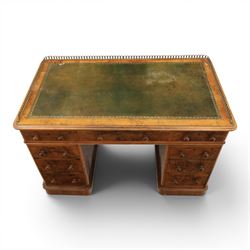 Victorian figured walnut twin pedestal desk, brass galleried top with inset tooled green leather writing surface, above three frieze drawers, raised on two pedestals with three drawers, on plinth bases above castors