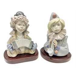 Two Lladro clown figures, comprising Sad Note no 5586, in original box and Fine Melody no 5585, both on a mahogany bases, largest example H18cm 