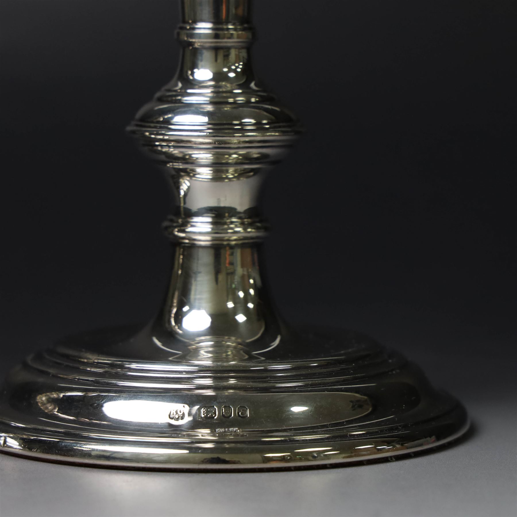 Pair of silver candlesticks, with knopped stems and upon spreading circular weighted bases, hallmarked William Comyns & Sons Ltd, London 1979, H20cm