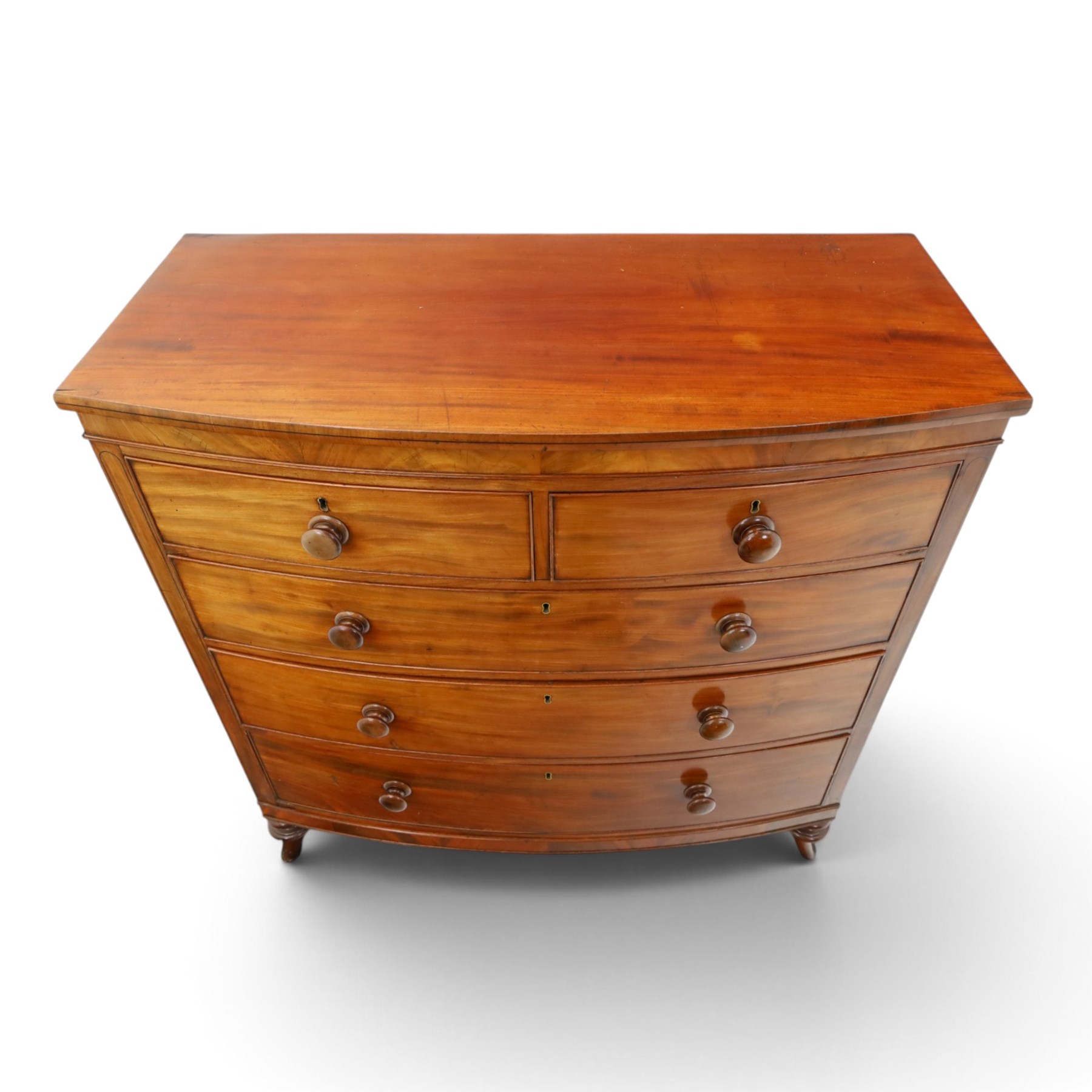 19th century mahogany bow-front chest, shaped top with ebony strung edge over banded frieze, fitted with two short over three long cock-beaded drawers, on turned feet