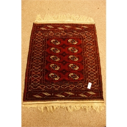  Small Bokhara pattern red ground rug, 117cm x 92cm, and two small Persian mats (3)  
