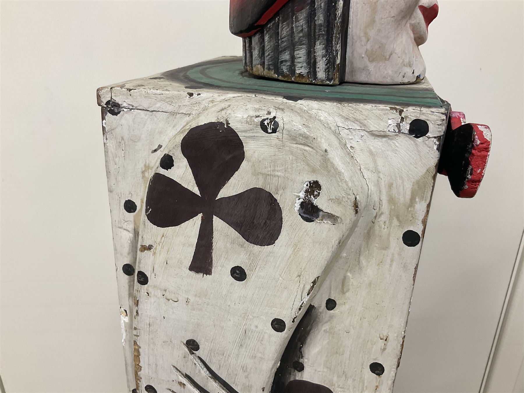 Folk art circus clown cabinet, the the two hinged doors with bow tie decoration opening to reveal fitted shelved interior, the body painted with polka dots and spades, H121cm